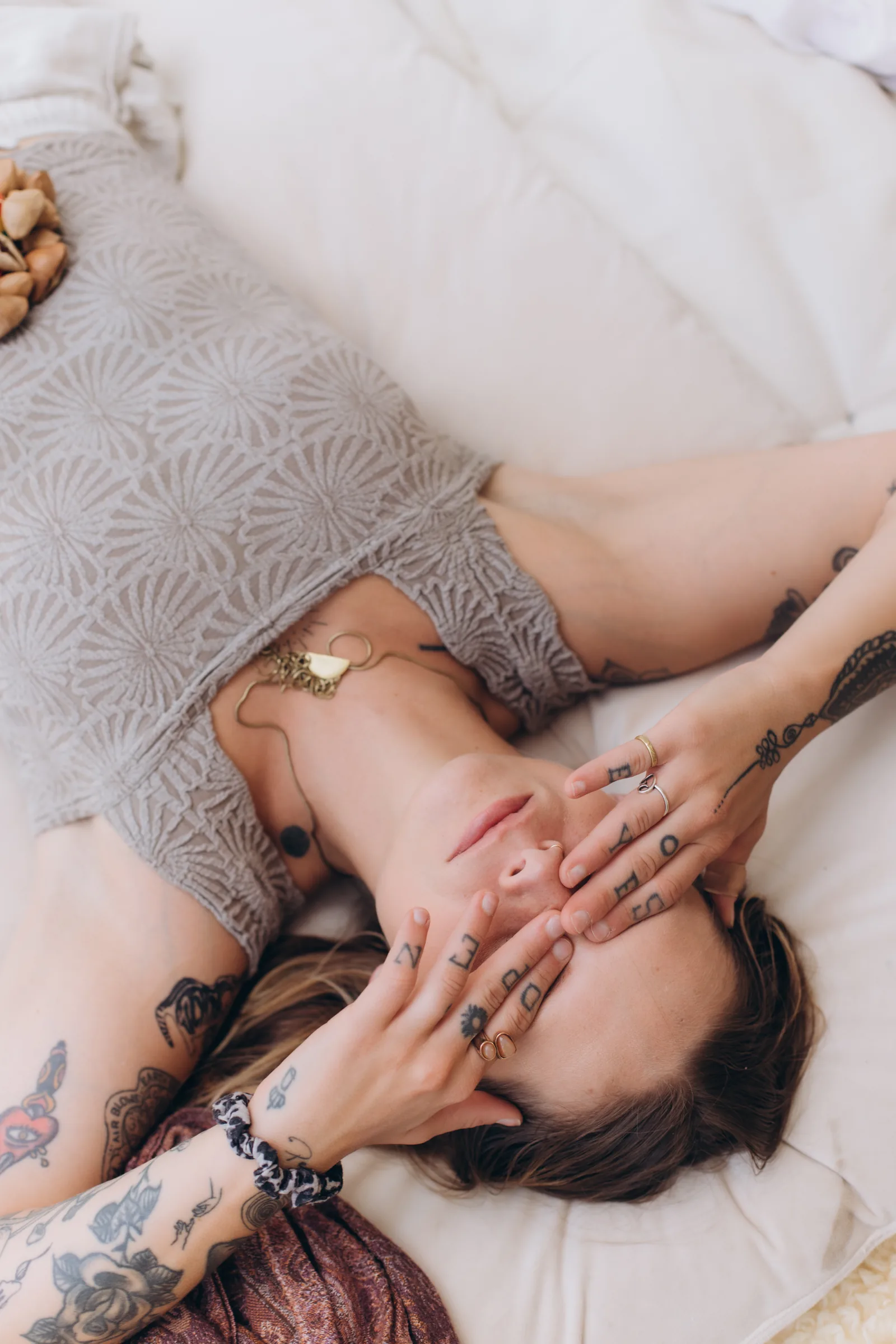 A client resting with hands held gently over her face